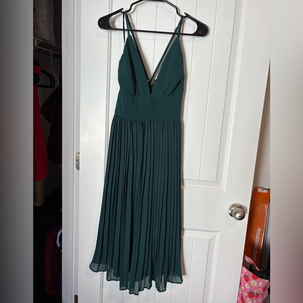 Lulu's “Love Me To The Moon Emerald Green Pleated Midi Dress”